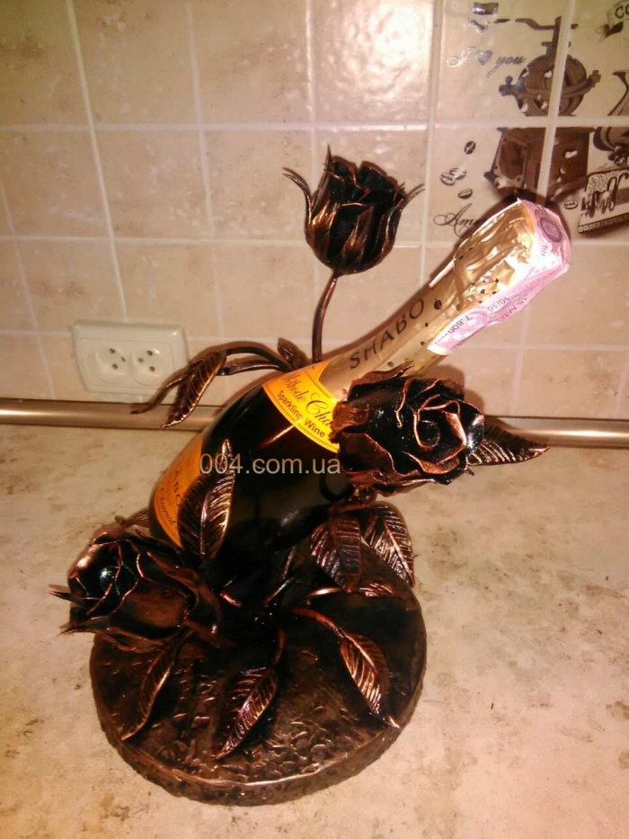 Кованная подставка для шампанского. Художественная ковка.
Кованное металлическое изделие подставка для шампанского с цветками и лепестками розы в цвет бронзы. Заказать красивую ковку: 096-9-004-004.